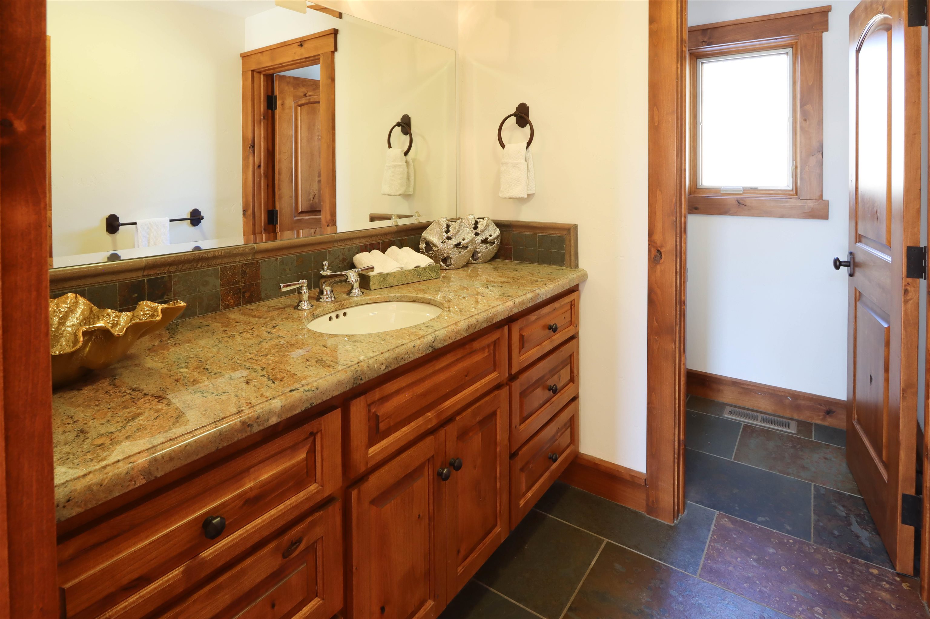 131 West Steelhead Road June Lake, CA 93529 - Photo 27 of 47 a bathroom with a granite countertop sink and a mirror