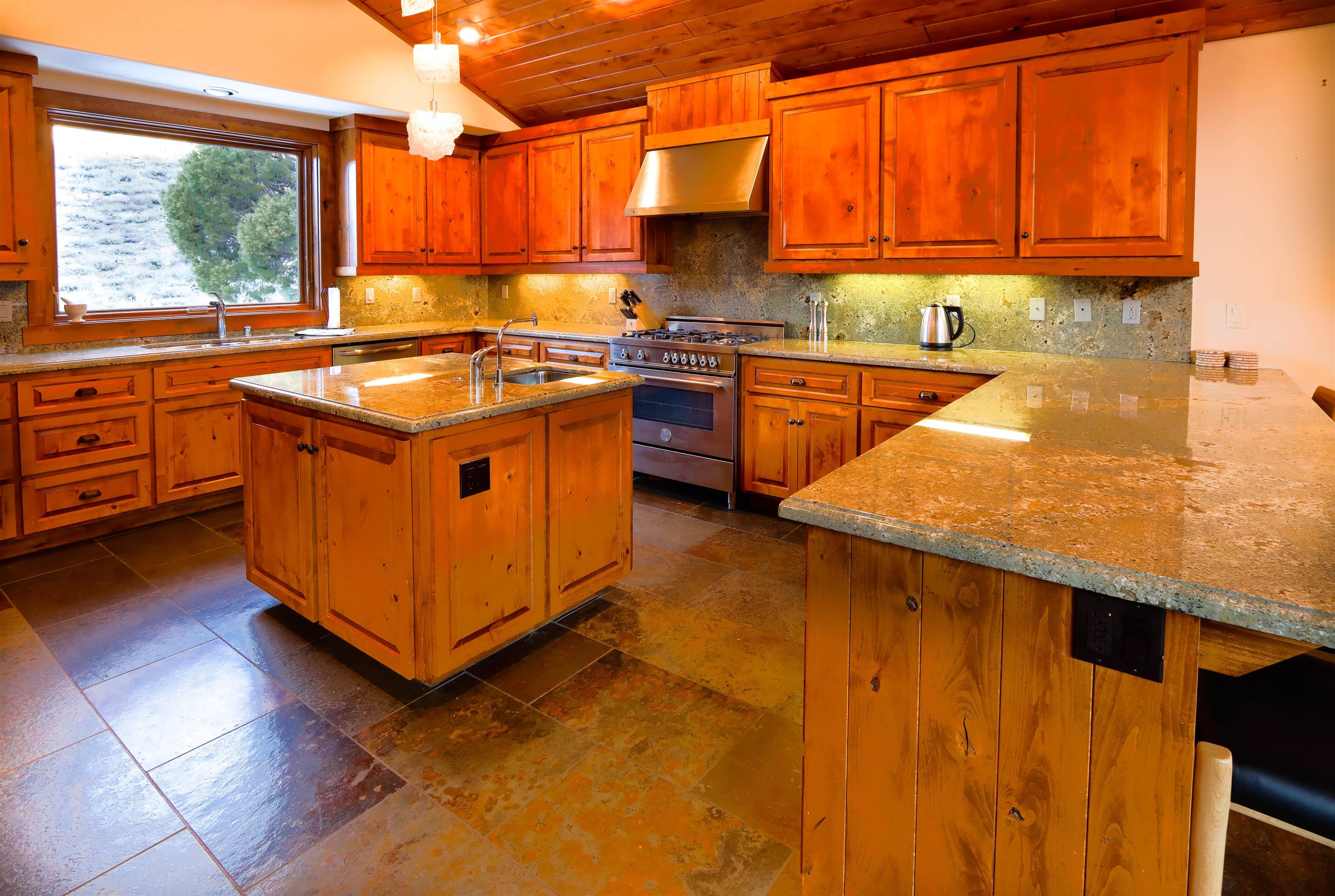 131 West Steelhead Road June Lake, CA 93529 - Photo 3 of 47 a kitchen with stainless steel appliances granite countertop a sink a stove and a refrigerator