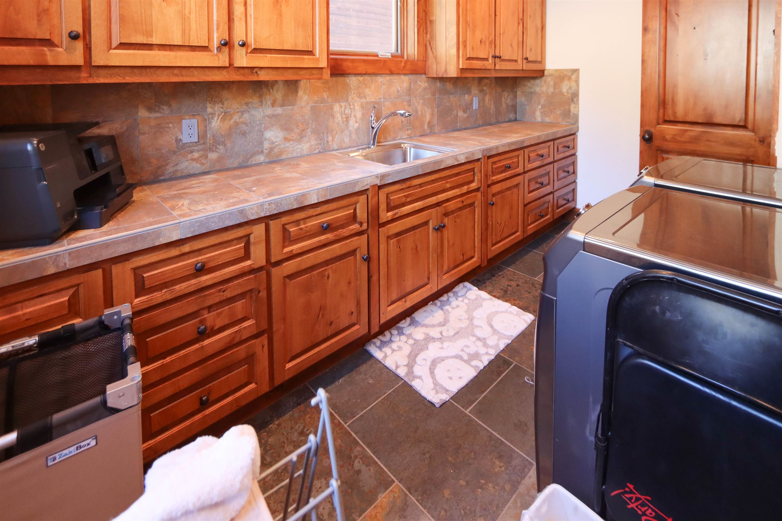 131 West Steelhead Road June Lake, CA 93529 - Photo 31 of 47 a kitchen with stainless steel appliances granite countertop a sink a stove and white cabinets with wooden floor