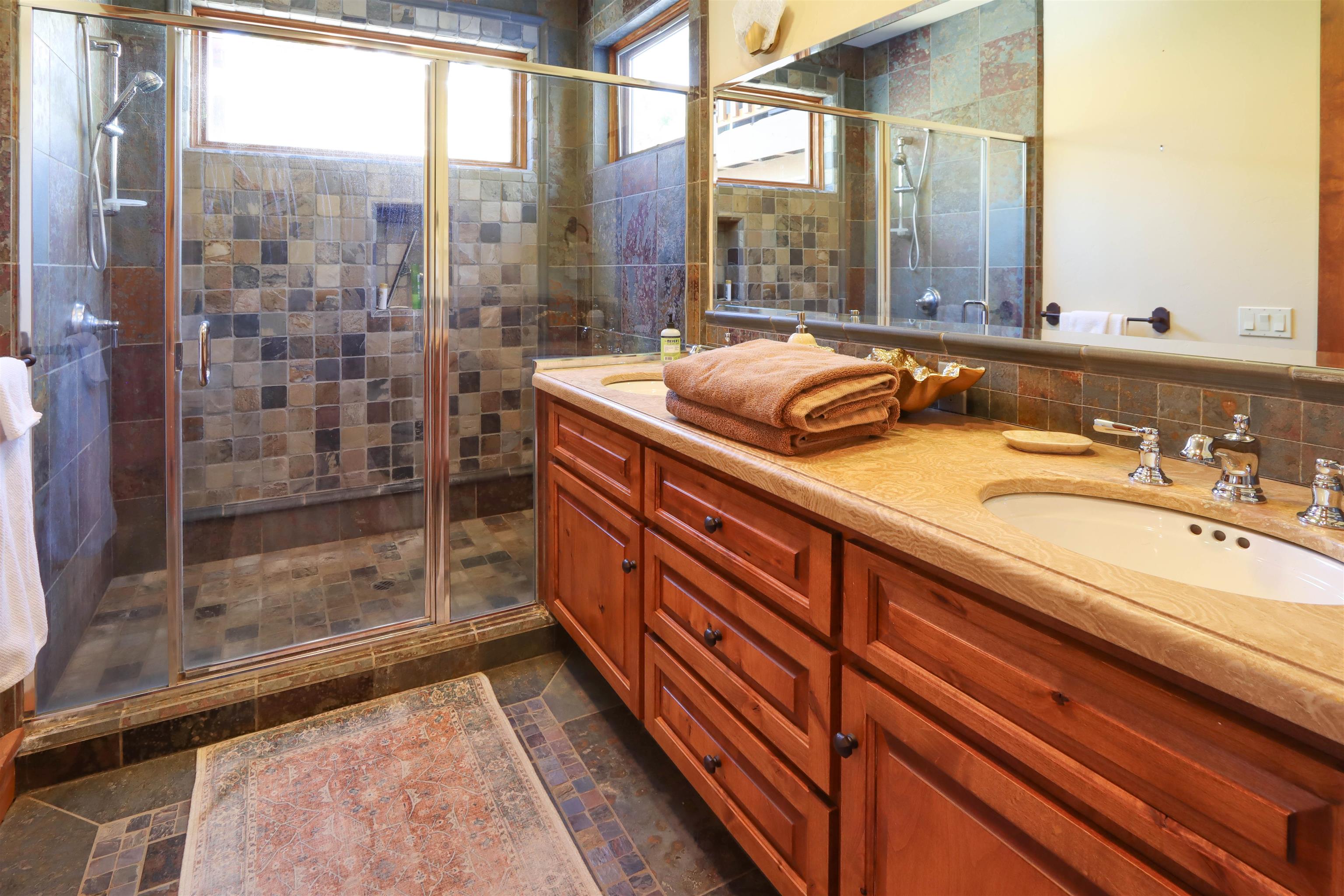 131 West Steelhead Road June Lake, CA 93529 - Photo 34 of 47 a bathroom with a granite countertop sink mirror and shower