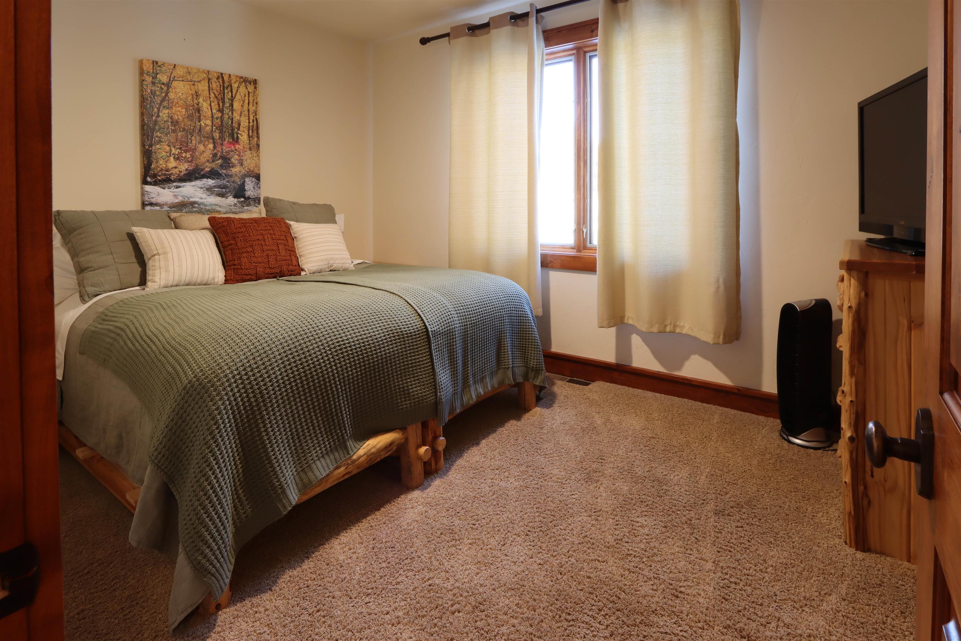 131 West Steelhead Road June Lake, CA 93529 - Photo 35 of 47 a bedroom with a bed tv and a window