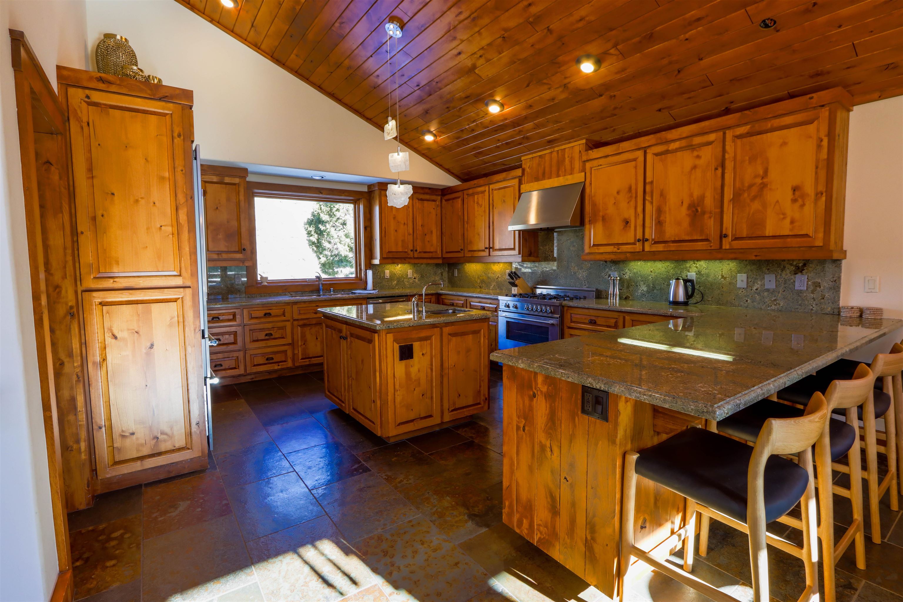 131 West Steelhead Road June Lake, CA 93529 - Photo 9 of 47 a kitchen with stainless steel appliances granite countertop a sink a stove and a refrigerator