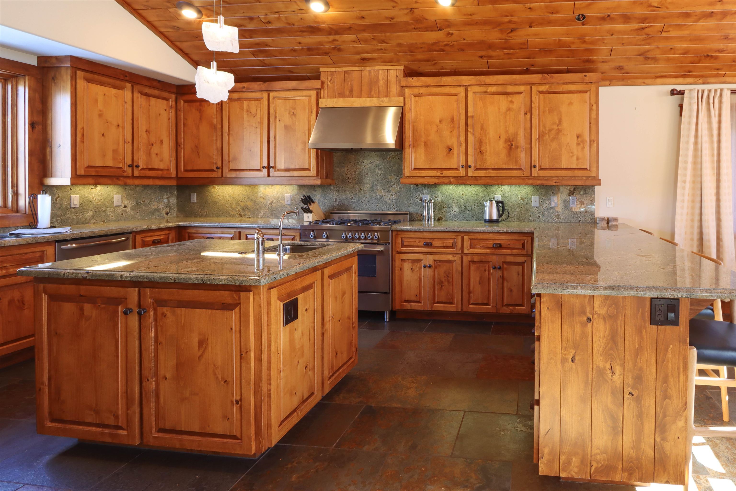 131 West Steelhead Road June Lake, CA 93529 - Photo 10 of 47 a kitchen with stainless steel appliances granite countertop a sink a stove and a refrigerator