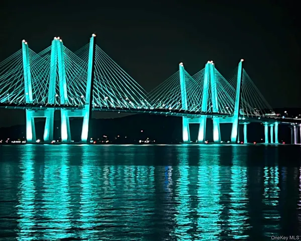 a view of building with river and trees in the background