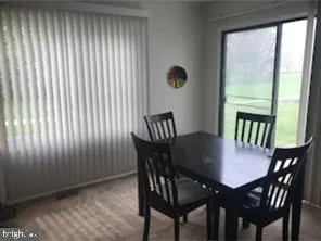 a view of a dining room with furniture and a window