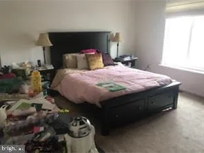 a bedroom with a bed and a potted plant