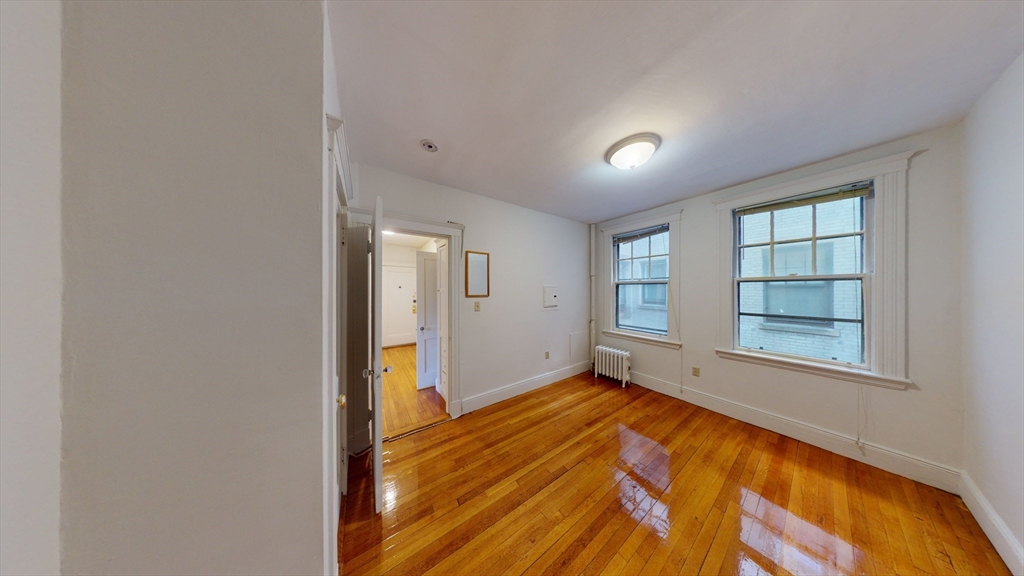 32 Sidlaw Road, Unit 7 Boston, MA 02135 - Photo 4 of 10 an empty room with windows