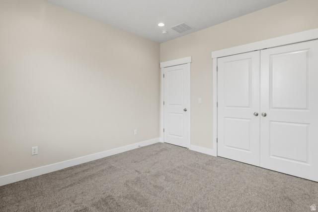 169 West 100 South Joseph, UT 84739 - Photo 26 of 35 Unfurnished bedroom featuring carpet flooring, a closet, and recessed lighting