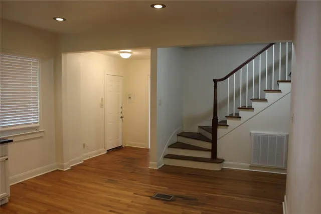 a view of entryway with wooden floor and stairs