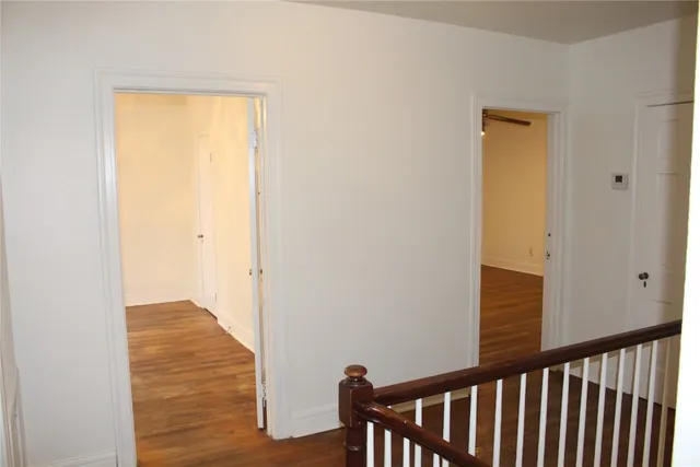 a view of hallway with wooden floor