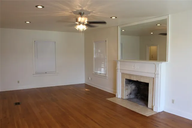wooden floor in an empty room with a fireplace