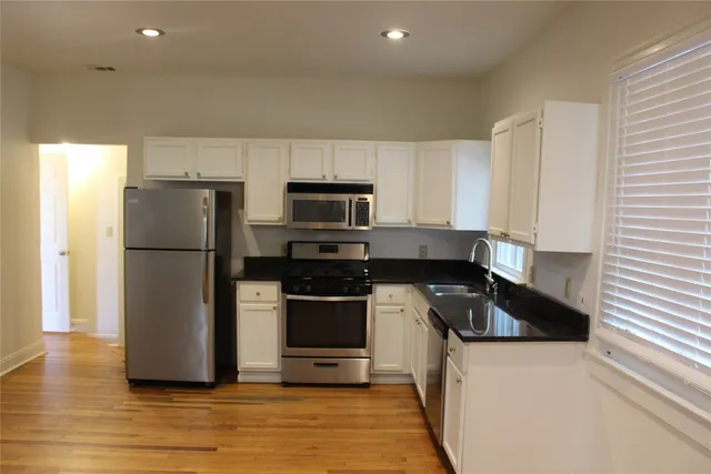 a kitchen with a refrigerator sink and microwave