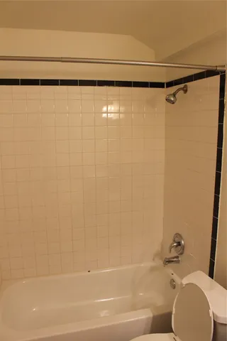 a bathroom with a shower and a toilet