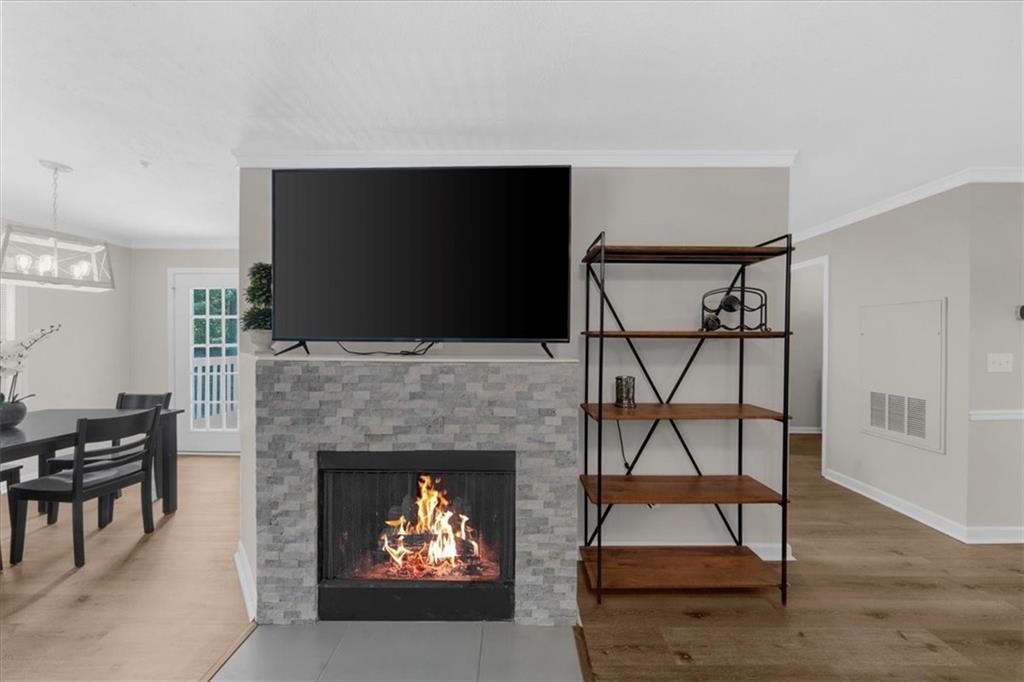 123 Streamside Drive Roswell, GA 30076 - Photo 11 of 36 a living room with a fireplace and a flat screen tv