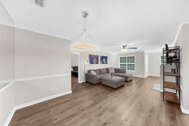 a living room with furniture and a wooden floor