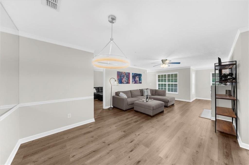 123 Streamside Drive Roswell, GA 30076 - Photo 13 of 36 a living room with furniture and a wooden floor
