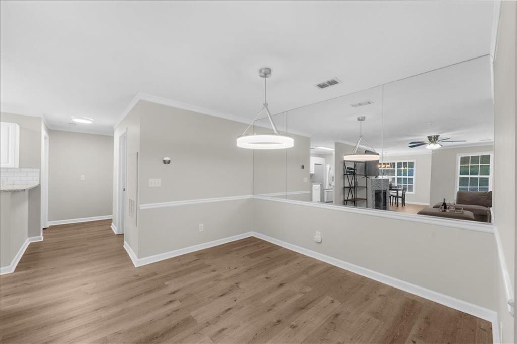 123 Streamside Drive Roswell, GA 30076 - Photo 14 of 36 an empty room with wooden floor and windows