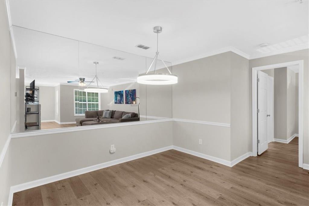 123 Streamside Drive Roswell, GA 30076 - Photo 15 of 36 an empty room with wooden floor and windows