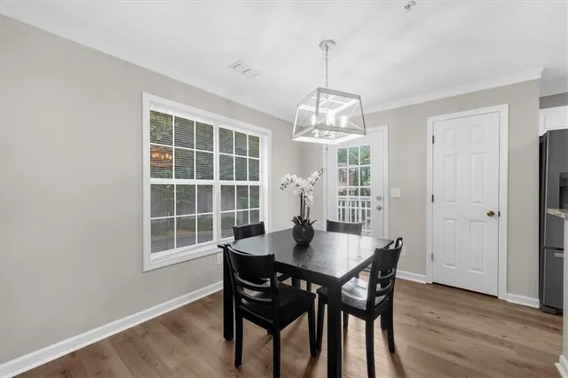 a view of a dining room with a table and chairs