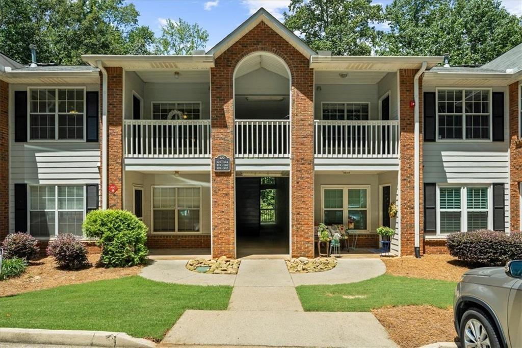 123 Streamside Drive Roswell, GA 30076 - Photo 2 of 36 a front view of a house with garden and porch
