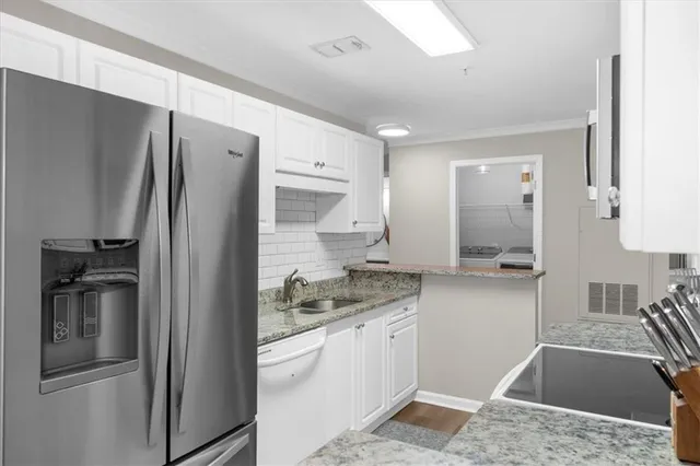 a kitchen with a refrigerator and a sink