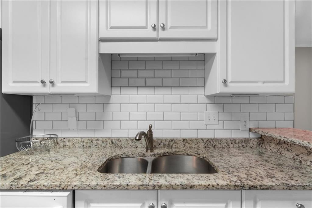 123 Streamside Drive Roswell, GA 30076 - Photo 24 of 36 a kitchen with granite countertop a sink and granite counter tops
