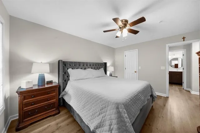 a bedroom with a bed and wooden floor
