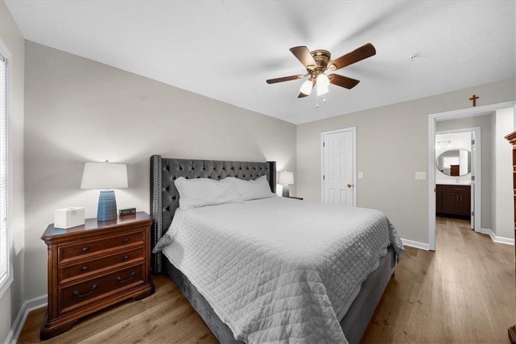 123 Streamside Drive Roswell, GA 30076 - Photo 26 of 36 a bedroom with a bed and wooden floor