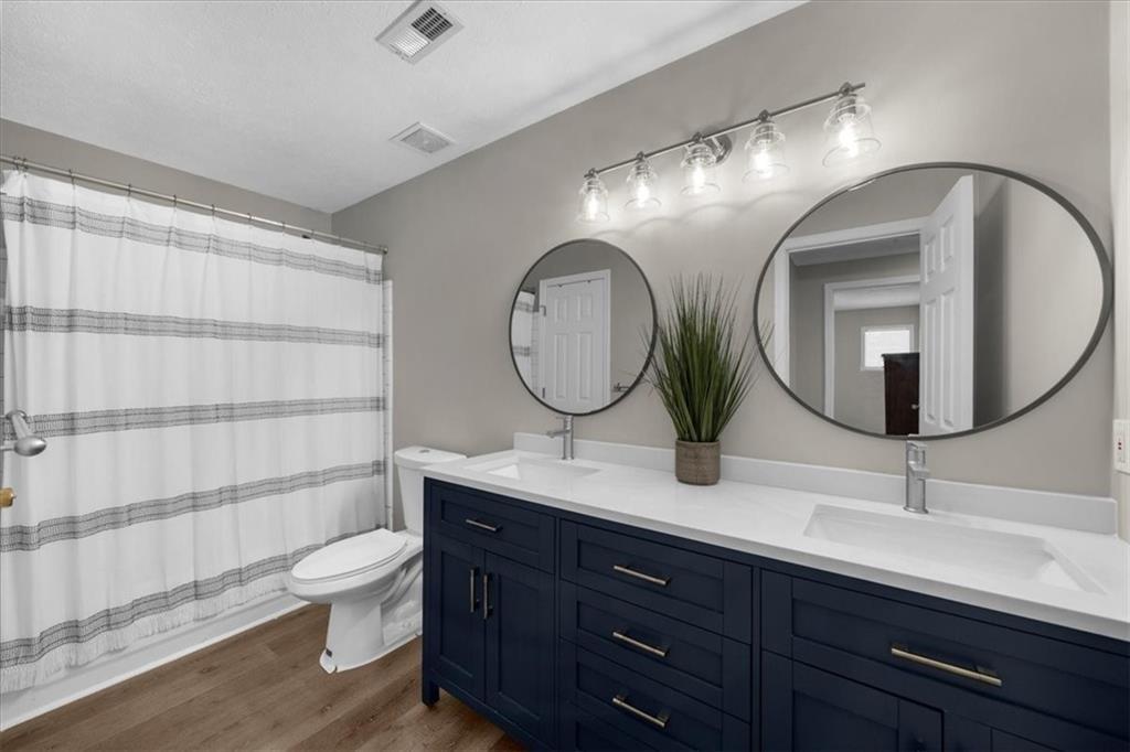 123 Streamside Drive Roswell, GA 30076 - Photo 27 of 36 a bathroom with a double vanity sink mirror and toilet