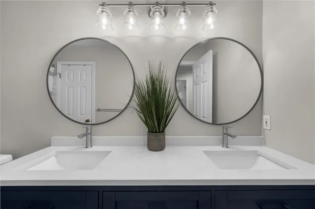 a bathroom with sinks and a mirror