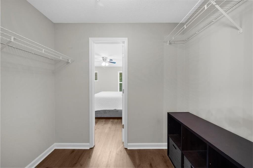 123 Streamside Drive Roswell, GA 30076 - Photo 29 of 36 a room that has a bed and a wooden floor