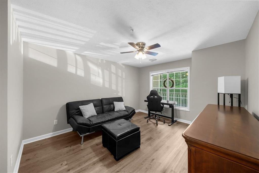 123 Streamside Drive Roswell, GA 30076 - Photo 31 of 36 a living room with furniture and a window