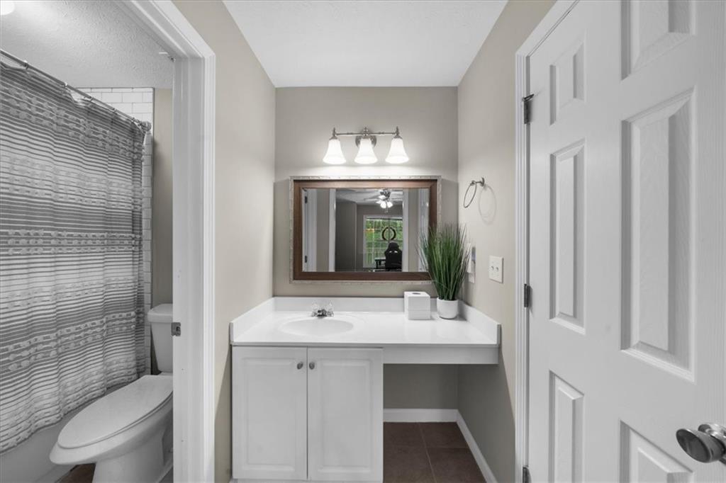 123 Streamside Drive Roswell, GA 30076 - Photo 32 of 36 a bathroom with a sink mirror and toilet