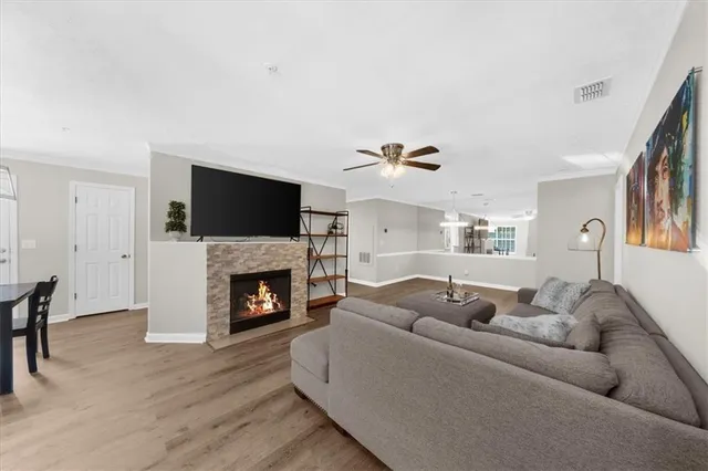 a living room with furniture a fireplace and a flat screen tv