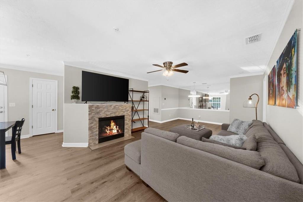 123 Streamside Drive Roswell, GA 30076 - Photo 7 of 36 a living room with furniture a fireplace and a flat screen tv