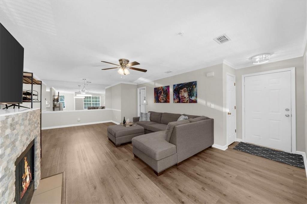123 Streamside Drive Roswell, GA 30076 - Photo 8 of 36 a living room with furniture and a flat screen tv