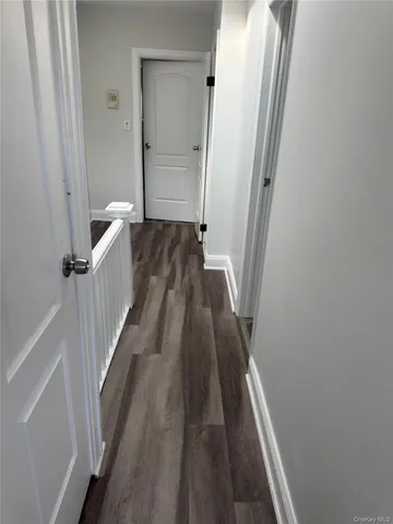 a view of a room with wooden floor and a window