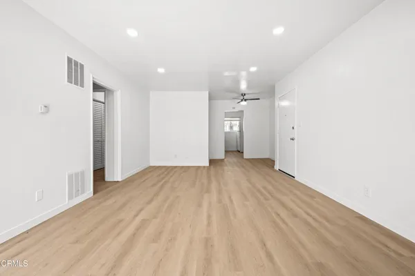 a view of a room with wooden floor and natural light