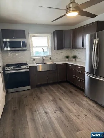 a kitchen with stainless steel appliances granite countertop a sink and stove top oven
