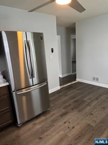 a view of a refrigerator in kitchen and wooden floor