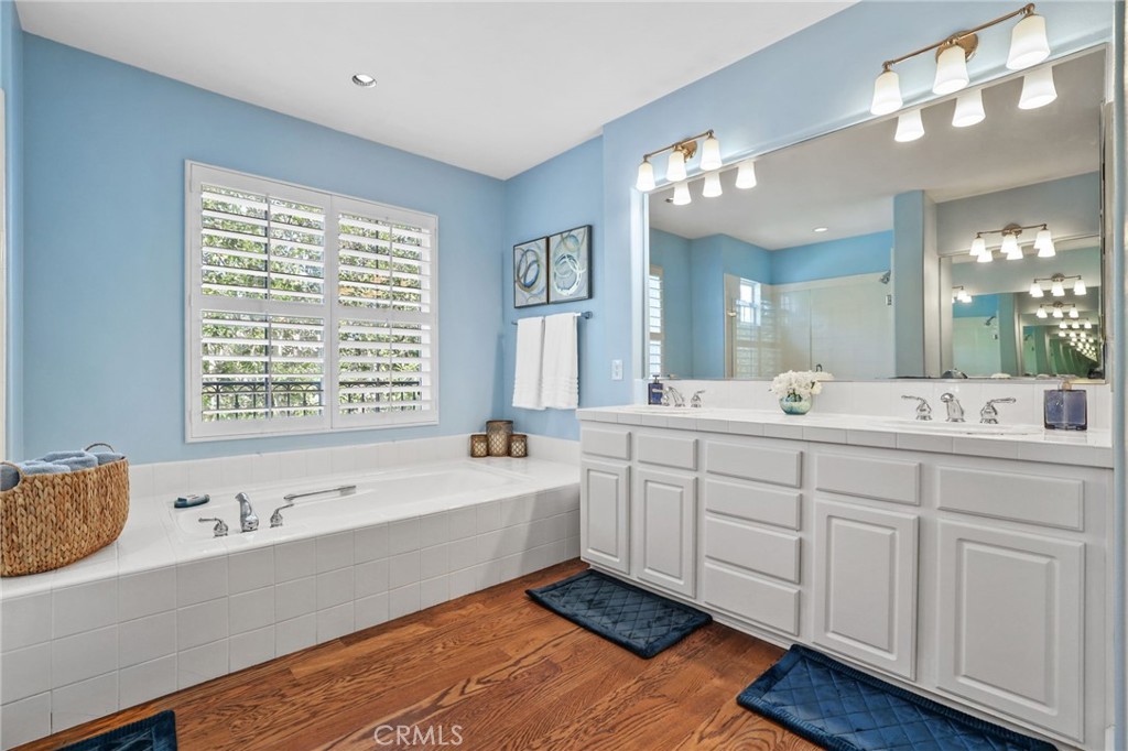 18 Lyon Newport Coast, CA 92657 - Photo 31 of 45 a spacious bathroom with double vanity a window a bathtub and mirrors