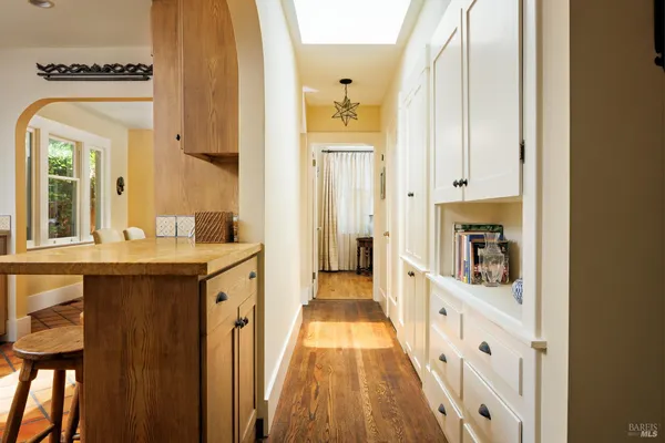 a kitchen with stainless steel appliances granite countertop a stove a sink dishwasher and microwave with wooden floor