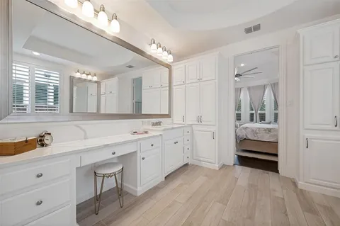 a spacious bathroom with a granite countertop sink and a mirror