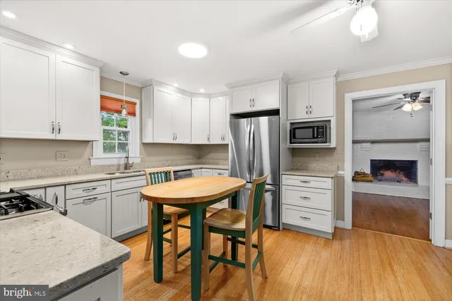 a kitchen with stainless steel appliances a stove a refrigerator sink and cabinets