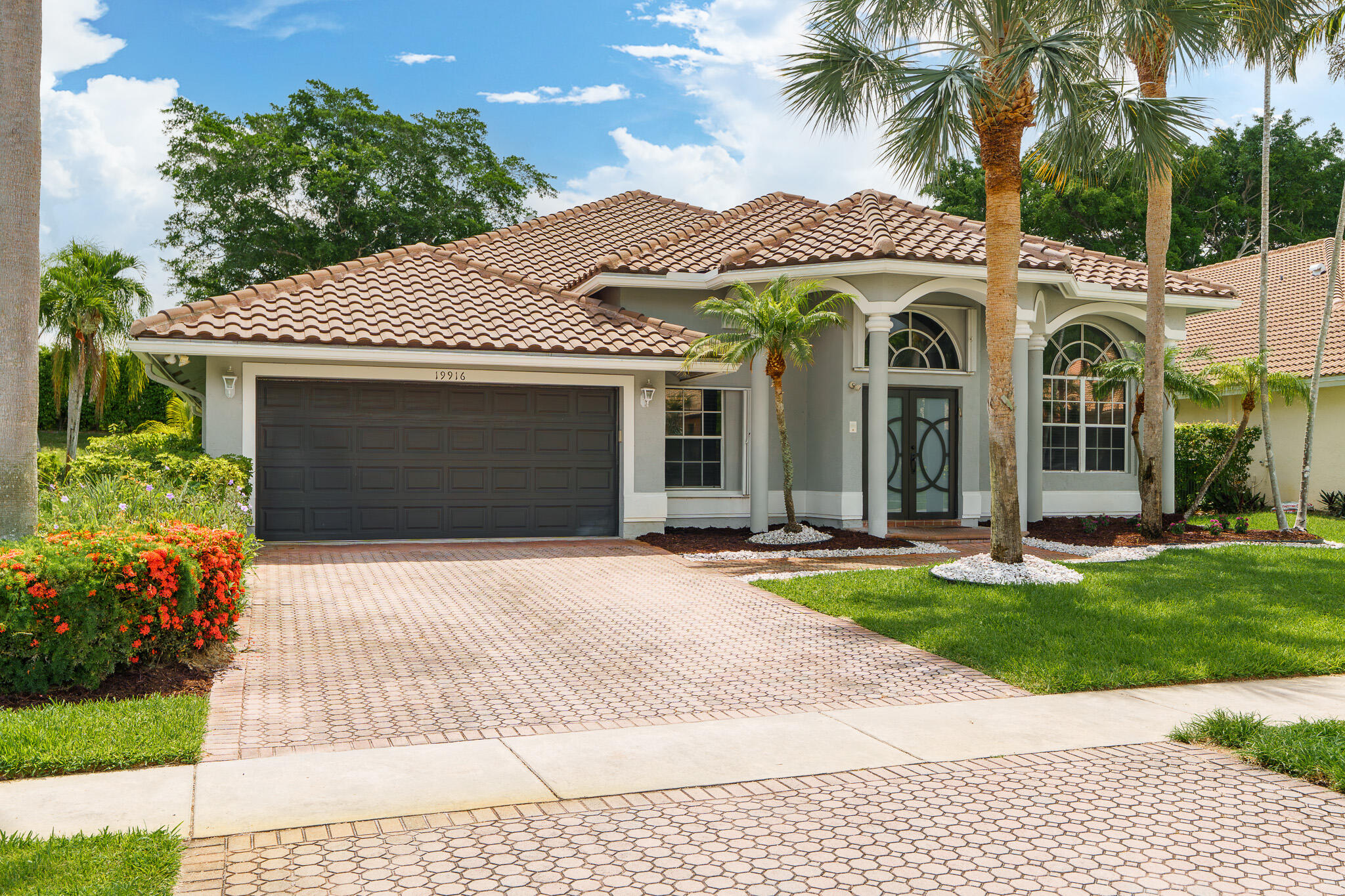 19916 Dinner Key Drive Boca Raton, FL 33498 - Photo 2 of 73 a front view of a house with a garden