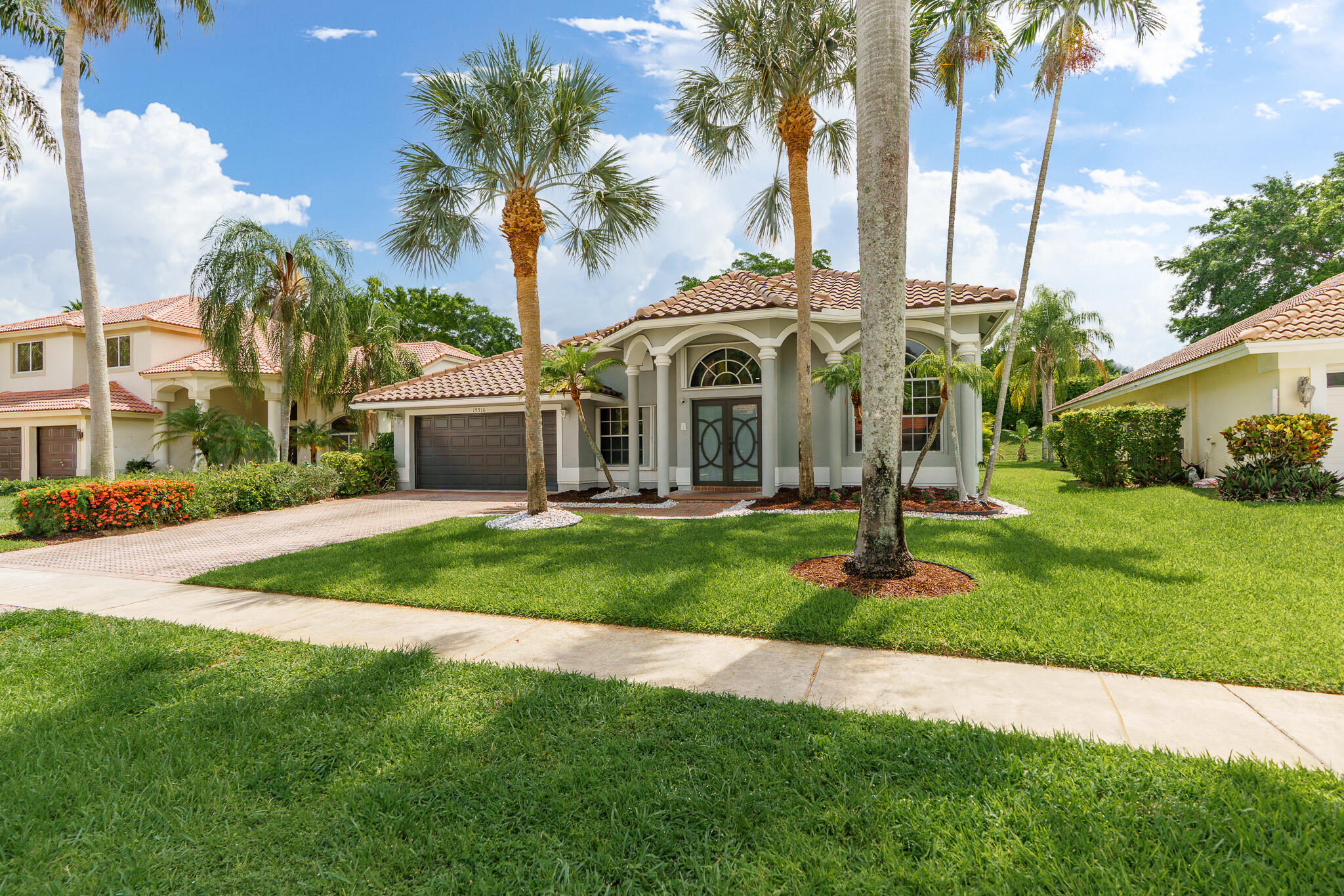 19916 Dinner Key Drive Boca Raton, FL 33498 - Photo 3 of 73 a front view of a house with garden