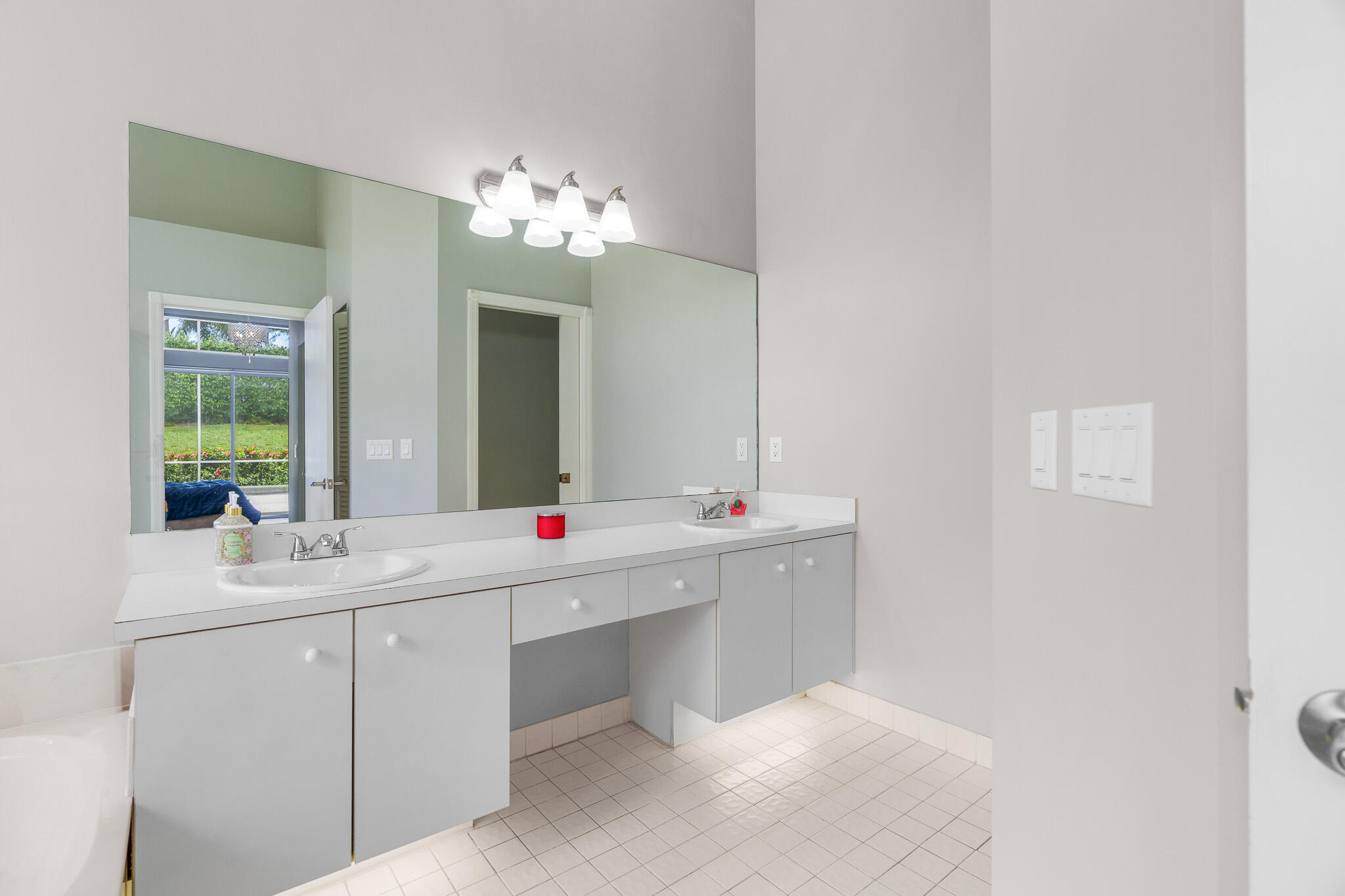 19916 Dinner Key Drive Boca Raton, FL 33498 - Photo 35 of 73 a bathroom with a double vanity sink and a mirror