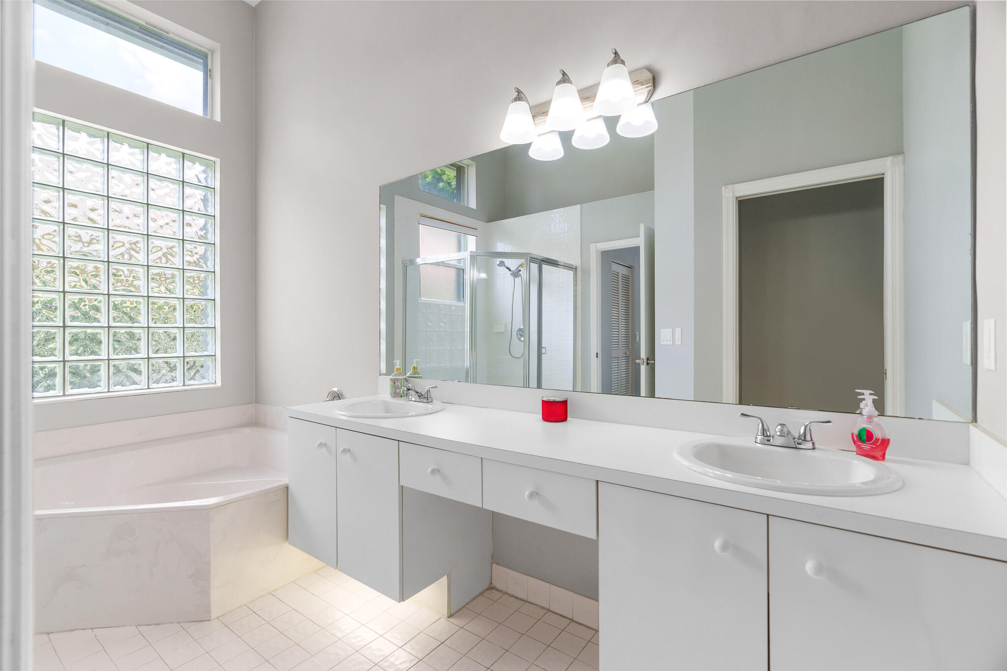 19916 Dinner Key Drive Boca Raton, FL 33498 - Photo 36 of 73 a bathroom with a tub sink and mirror