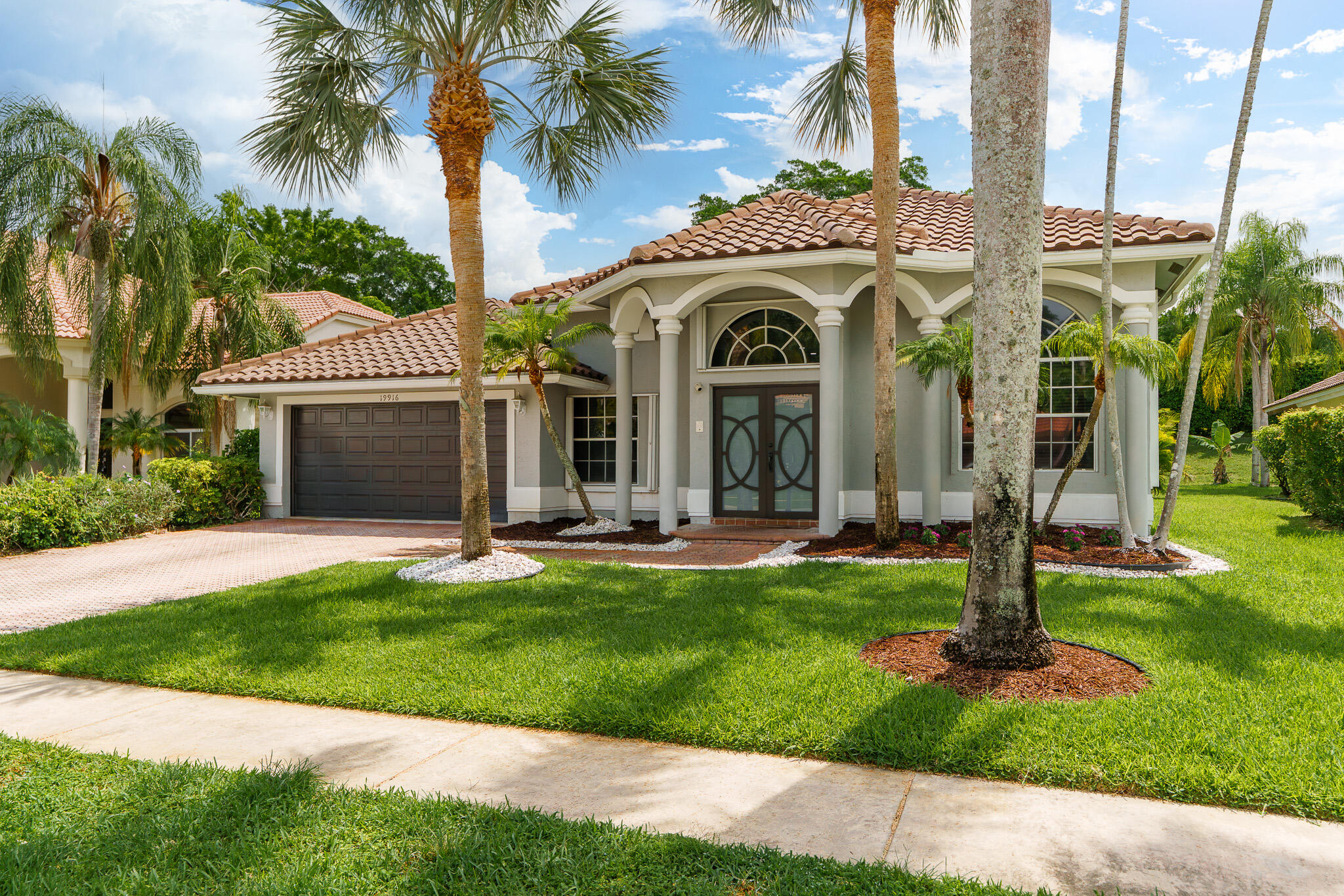 19916 Dinner Key Drive Boca Raton, FL 33498 - Photo 4 of 73 a front view of a house with yard and green space