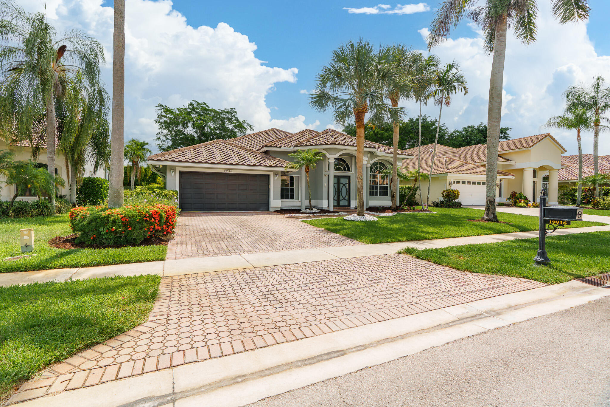 19916 Dinner Key Drive Boca Raton, FL 33498 - Photo 5 of 73 a front view of a house with a yard and potted plants